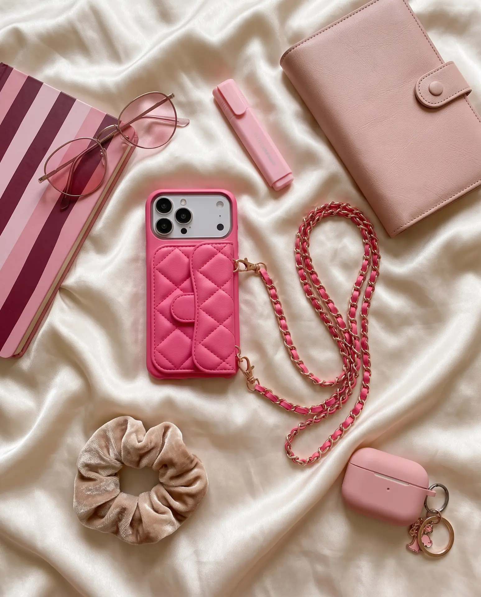 Powder Pink phone purse with a full-length pocket on cream silk with a pink wallet, sunglasses and a scrunchie