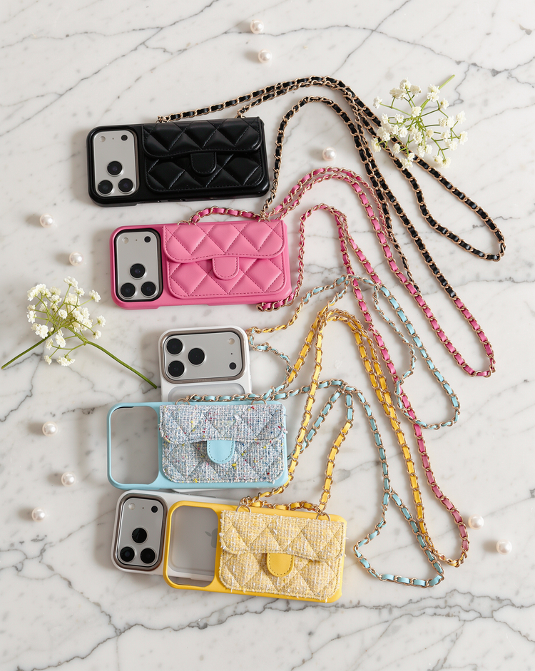 Black, pink, sky blue tweed and lemon tweed cases with their chains on marble